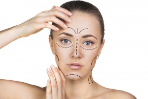 Beautician drawing perforation lines on woman face